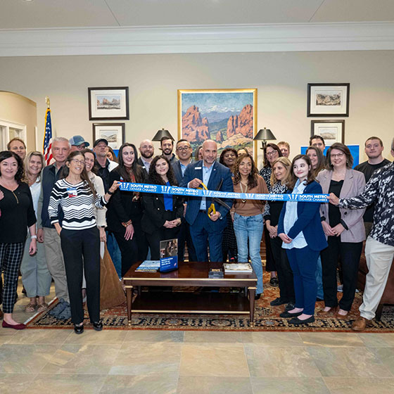 Large group of South Metro business owners supporting their community through a ribbon cutting ceremony